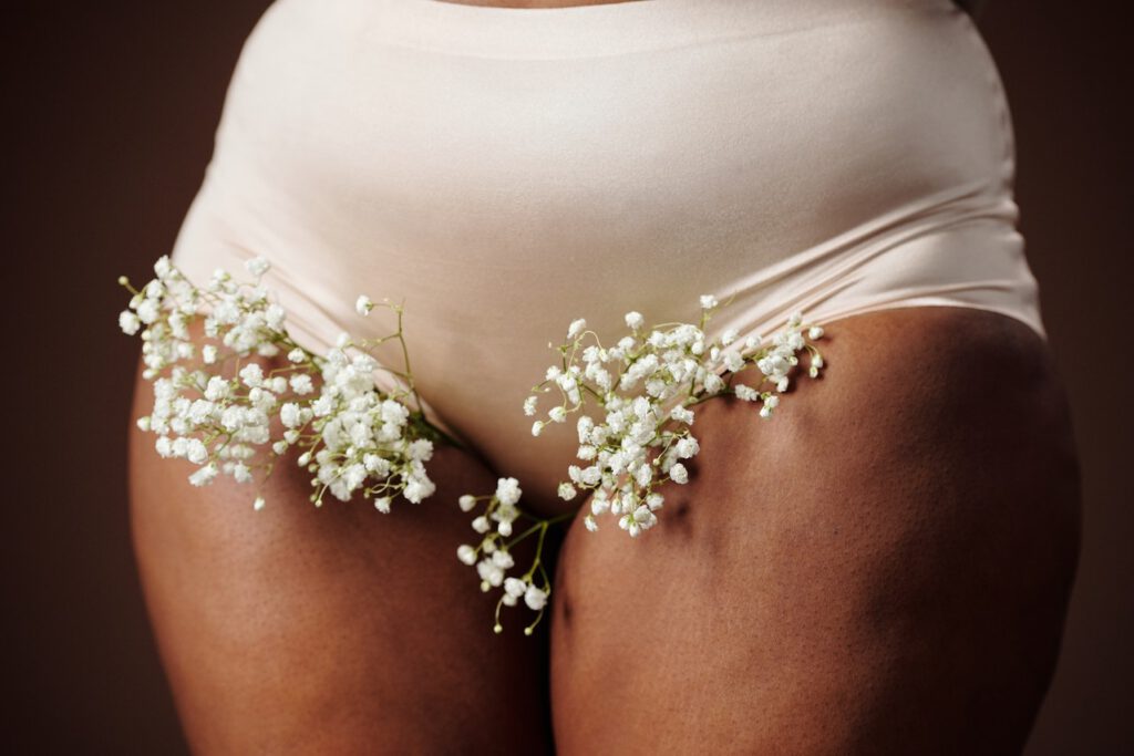 Woman with flowers as pubic hair coming out of the underwear